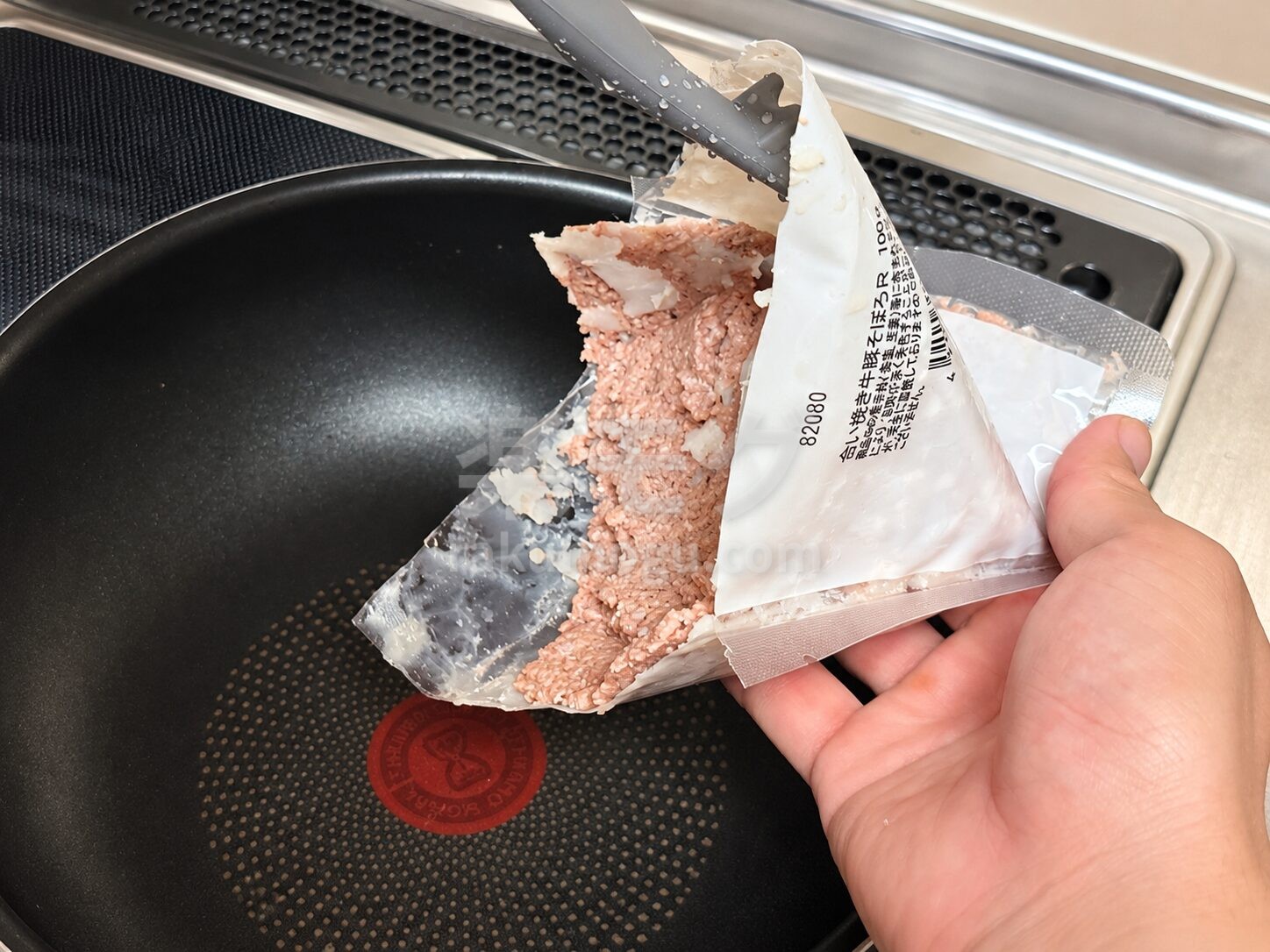 合いびきそぼろを袋からフライパンに入れる